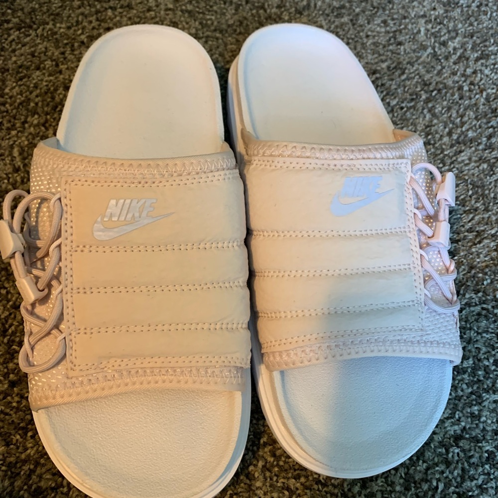 Pink and white Nike slides